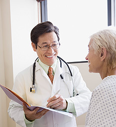 Smiling doctor with patient and file