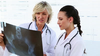 stock-footage-doctor-and-nurse-discussing-xray-in-office-at-the-hospital