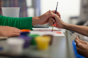 Amy Bucciarelli, MS ATR-BC, LMHC, Board Certified Art Therapist, helped Frank "Dylan" Dinkins make a painting for his parents. Bucciarelli works with pedatrics patients at UF Health Shands Children's Hospital.