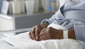 Jersey City, New Jersey, USA --- Black woman recovering in hospital bed --- Image by © JGI/Tom Grill/Blend Images/Corbis